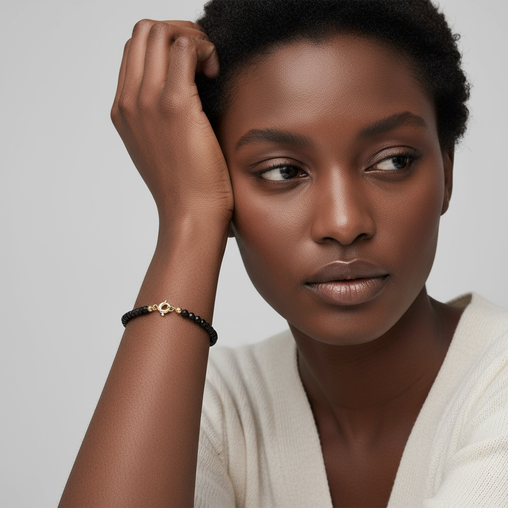 Etheris | Energy Bracelets | Woman with a thoughtful expression, wearing an obsidian bracelet on a plain background