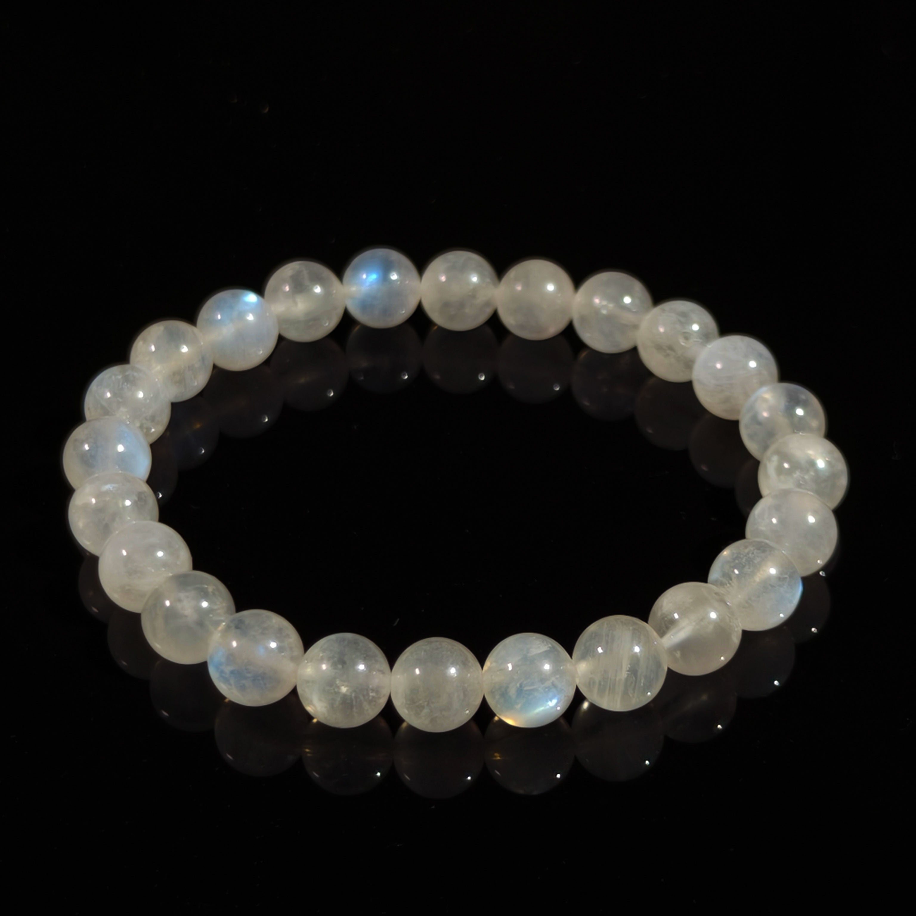 Natural moonstone bracelet with polished round beads and blue shimmer for calm energy.